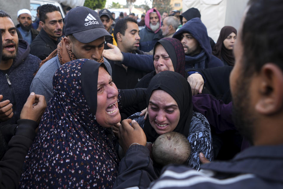 Palestinians mourn a baby killed in the Israeli bombardments of the Gaza Strip in front of the morgue of the Al Aqsa Hospital in Deir al Balah on Saturday, Feb. 24, 2024. (AP Photo/Adel Hana)