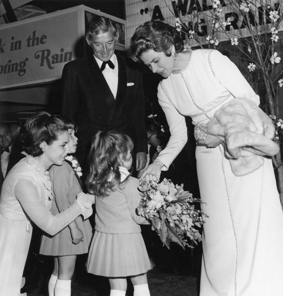 Actress Ingrid Bergman, receives flowers at the 1970 premiere of “A Walk in the Spring Rain” at the Capri 70 Movie Theatre, from Patricia Lynn Simpson, 4, while Mrs. James M. Simpson and Mary Katherine Simpson, 5 and Director Guy Green, watch, April, 10, 1970.