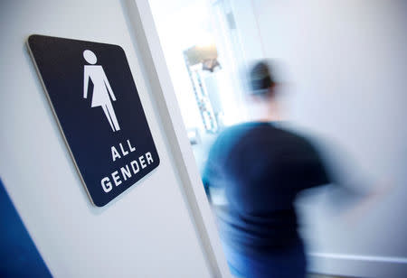 FILE PHOTO - A bathroom sign welcomes both genders at the Cacao Cinnamon coffee shop in Durham, North Carolina, U.S. on May 3, 2016. REUTERS/Jonathan Drake/File Photo