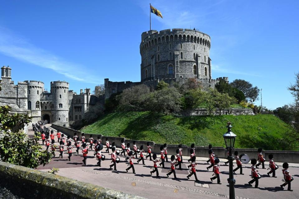 <p>The Foot Guards march on the grounds of Windsor. </p>