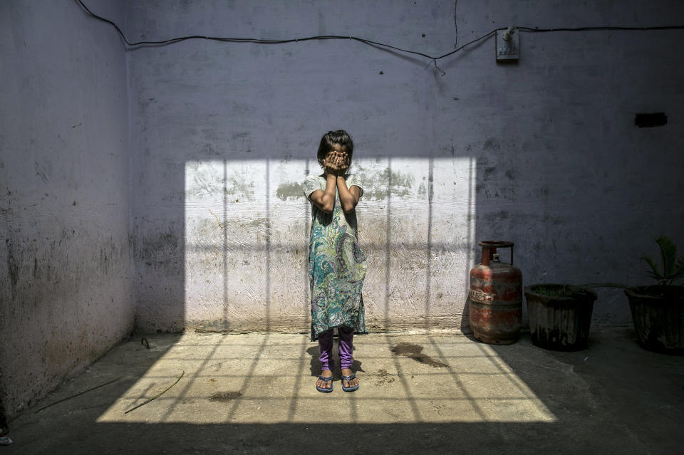 UTTAR PRADESH, INDIA - SEPTEMBER 8:  8 year old Sadaf (name changed) stands for a photo in her home on September 8, 2016 in Uttar Pradesh, India. 3 months ago she was raped by a doctor in her village. She was walking to the market to buy sweets when the doctor, who her family estimates is around 50 years old, forcefully pulled her inside his clinic and raped her. Afterwards she stumbled out onto the street and fainted. When her family found her she was covered in blood and profusely bleeding. She told them what happened and they went to the police but the police refused to register a case, they said that they should compromise because the doctor was offering them 2 lakh rupees (around $2,989) to drop the case. The family refused, and says 'They destroyed the life of our child, how can we compromise?'. They estimate that they and their neighbors had to go to the police station 10 times before the police agreed to register the case. For 5 days after the rape, Sadaf bled and they had to shuffle from hospital to hospital looking for a hospital that had facilities that could provide adequate care for her. Since the rape Sadaf has been sick and week and is too afraid to leave the house or return to school. The family is also afraid to let her leave the house because they say the rapist comes from a rich and powerful family and could harm her or kidnap her. Before the rape she enjoyed going to school and dreamed of being an English teacher when she grows up. She loved to play board games and cricket with her best friend, Nisha, but she hasn't seen her for 3 months. Sadaf's uncle, who is fighting the case, has taken out two loans to help pay for transportation to the court house and for lawyer bills. Every time he has to go to court he must take off work from his job as a day laborer. (Photo by Getty Images)