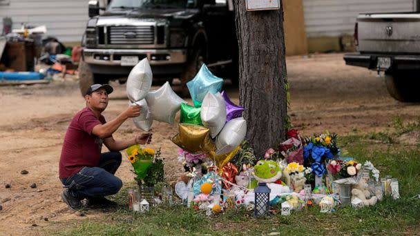 PHOTO: A man releases a balloon from the makeshift memorial outside the victims' home, May 2, 2023, where a mass shooting occurred Friday, in Cleveland, Texas. (David J. Phillip/AP)