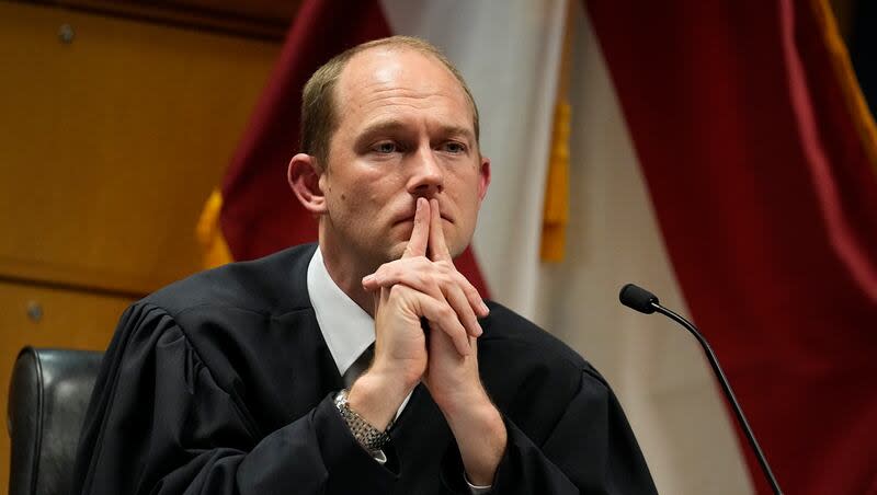 Fulton County Superior Judge Scott McAfee presides in court, Feb. 27, 2024, in Atlanta. The judge overseeing the Georgia election interference case has dismissed some of the charges against former President Donald Trump, but others remain. McAfee wrote Wednesday in an order that six of the charges in the indictment must be quashed, including three against Trump.