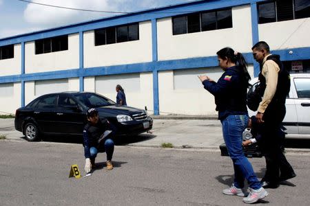 Police officers and criminal investigators inspect the area where a woman was shot when looters raided state food warehouses, in San Cristobal, Venezuela, June 6, 2016. REUTERS/Carlos Eduardo Ramirez