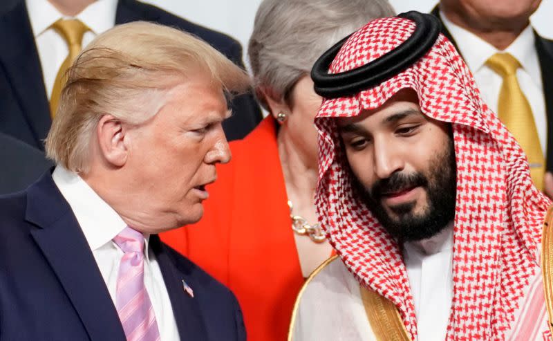 FILE PHOTO: U.S. President Donald Trump speaks with Saudi Arabia's Crown Prince Mohammed bin Salman during family photo session with other leaders and attendees at the G20 leaders summit in Osaka