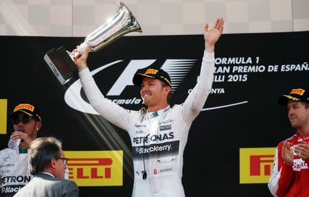 Formula One - F1 - Spanish Grand Prix 2015 - Circuit de Catalunya, Barcelona, Spain - 10/5/15 Mercedes' Nico Rosberg celebrates his win on the podium with the trophy Reuters / Juan Medina