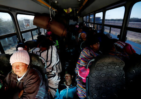 Migrants, part of a caravan of thousands traveling from Central America to the United States, ride on a bus which is on the way to Mexicali, in Navojoa, Mexico November 17, 2018. REUTERS/Kim Kyung-Hoon?