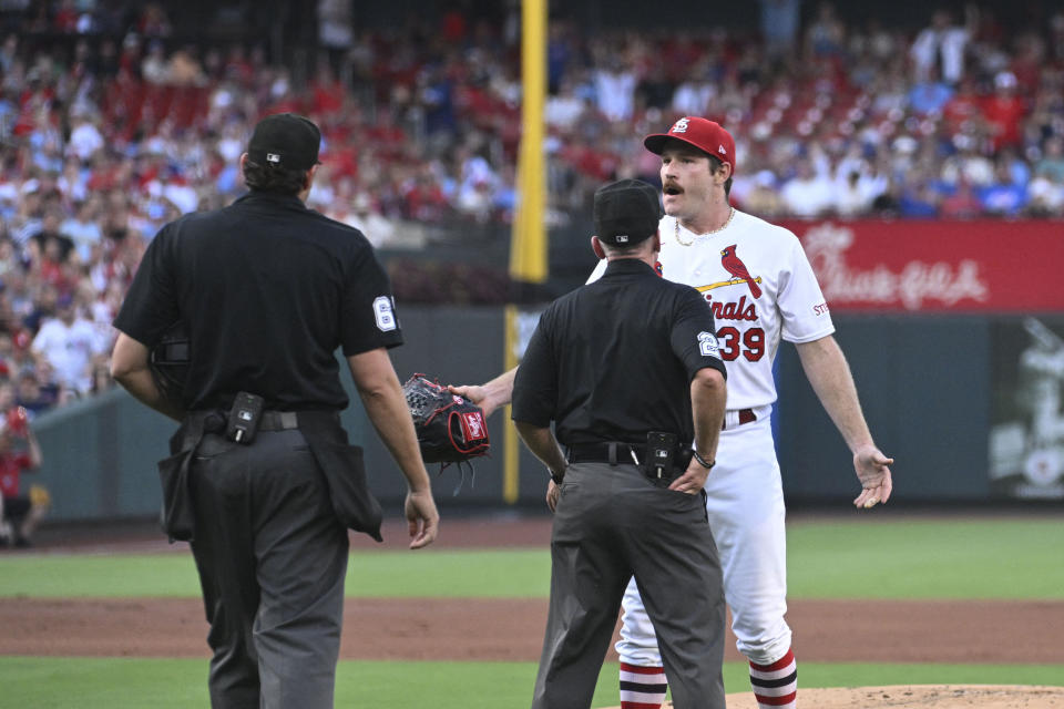 Jul 27, 2023; St. Louis, Missouri, USA; St. Louis Cardinals starting pitcher Miles Mikolas (39) argues with umpire Ryan Additon (67) and umpire Lance Barksdale (23) after being ejected against the Chicago Cubs in the first inning at Busch Stadium. Mandatory Credit: Joe Puetz-USA TODAY Sports