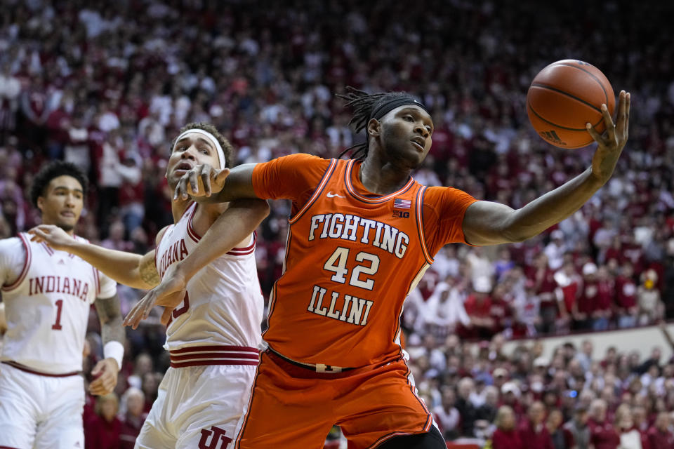 Illinois forward Dain Dainja (42) grabs a rebound in front of Indiana forward Race Thompson (25) in the first half of an NCAA college basketball game in Bloomington, Ind., Saturday, Feb. 18, 2023. (AP Photo/Michael Conroy)