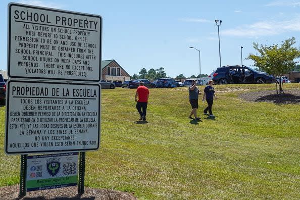 WINDER, GEORGIA - SEPTEMBER 4: Students walk off campus with their families after a shooting at Apalachee High School on September 4, 2024 in Winder, Georgia. Four fatalities and multiple injuries have been reported, and a 14-year-old suspect is in custody according to authorities. (Photo by Megan Varner/Getty Images)