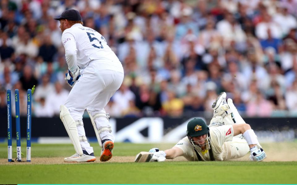 Steve Smith of Australia makes his ground as Jonny Bairstow of England knocks the bails off with his glove before receiving the ball