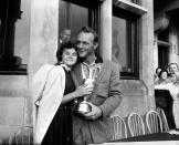 <p>Arnold Palmer is pictured with his wife Winnie, holding the Claret Jug after his victory, surrounded by well-wishers, Palmer won the tournament with a four round aggregate of 276 shots (Photo by Bob Thomas/Getty Images) </p>