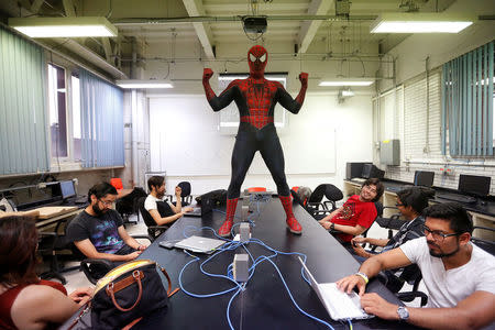 Moises Vazquez, 26, known as Spider-Moy, a computer science teaching assistant at the Faculty of Science of the National Autonomous University of Mexico (UNAM), who teaches dressed as a comic superhero Spider-Man, poses for a photograph during a class in Mexico City, Mexico, May 27, 2016. REUTERS/Edgard Garrido