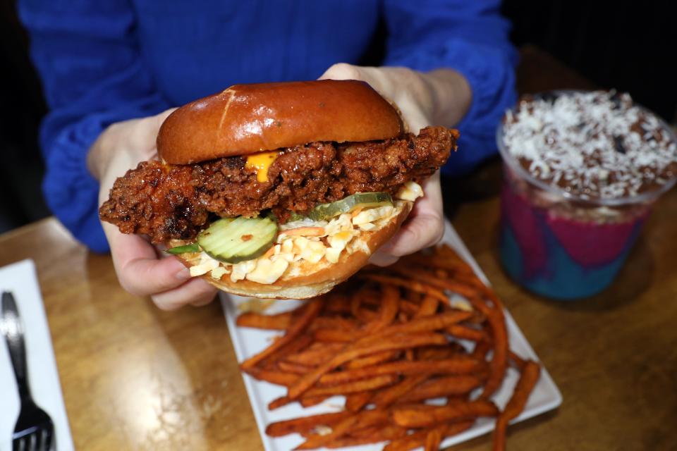 The Dave's Hot Chicken Sandwich with sweet potato fries and the Carnival açai bowl at The Peach Pit Bowl Shop & Kitchen in New City March 13, 2024.