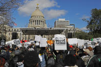 Several hundred people gather in front of the Mississippi Capitol in Jackson, on Friday, Jan. 24, 2020, to protest conditions in prisons where inmates have been killed in violent clashes in recent weeks. Mississippi's new governor says he and the interim corrections commissioner toured a troubled state prison to see conditions and to try to understand what led to an outburst of deadly violence in recent weeks. (AP Photo/Rogelio V. Solis)