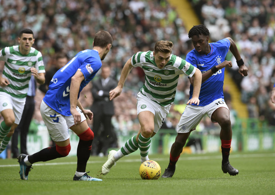 Celtic's James Forrest, centre, wins the ball from Rangers' Oviemuno Ejaria, during the Scottish Premiership soccer match between Celtic and Rangers, at Celtic Park, in Glasgow, Scotland, Sunday, Sept. 2, 2018. (Ian Rutherford/PA via AP)