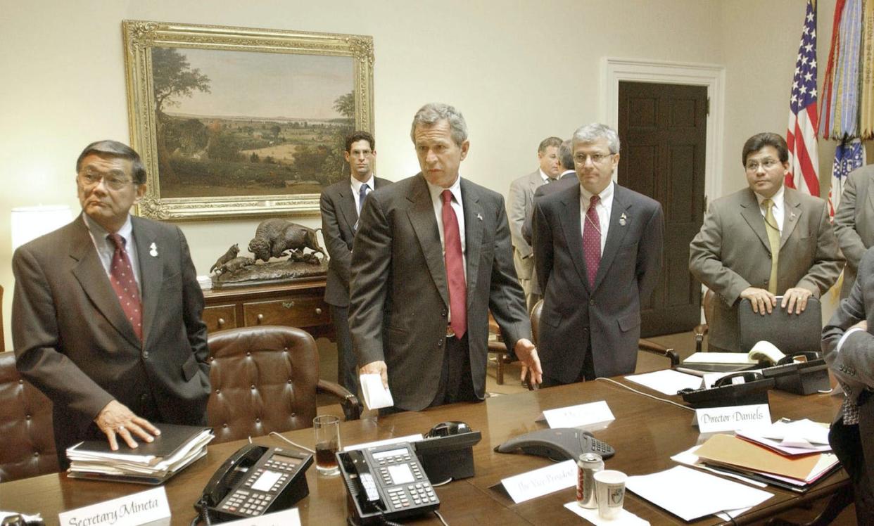 <span class="caption">On Sept. 17, 2001, Transportation Secretary Norman Mineta, left, met with President <span class="caas-xray-inline-tooltip"><span class="caas-xray-inline caas-xray-entity caas-xray-pill rapid-nonanchor-lt" data-entity-id="George_W._Bush" data-ylk="cid:George_W._Bush;pos:1;elmt:wiki;sec:pill-inline-entity;elm:pill-inline-text;itc:1;cat:Politician;" tabindex="0" aria-haspopup="dialog"><a href="https://search.yahoo.com/search?p=George%20W.%20Bush" data-i13n="cid:George_W._Bush;pos:1;elmt:wiki;sec:pill-inline-entity;elm:pill-inline-text;itc:1;cat:Politician;" tabindex="-1" data-ylk="slk:George W. Bush;cid:George_W._Bush;pos:1;elmt:wiki;sec:pill-inline-entity;elm:pill-inline-text;itc:1;cat:Politician;" class="link ">George W. Bush</a></span></span> and others.</span> <span class="attribution"><a class="link " href="https://www.gettyimages.com/detail/news-photo/president-george-w-bush-meeting-with-transportation-secy-news-photo/50369139" rel="nofollow noopener" target="_blank" data-ylk="slk:Greg Mathieson/Mai/Getty Images;elm:context_link;itc:0;sec:content-canvas">Greg Mathieson/Mai/Getty Images</a></span>