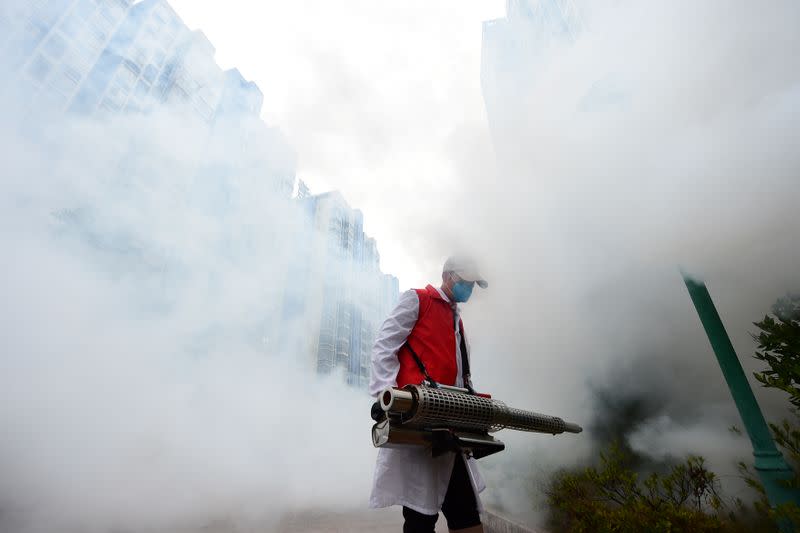 Volunteer disinfects a residential compound to prevent and control the novel coronavirus, in Ganzhou