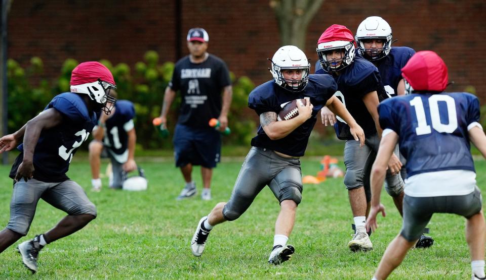 Westerly players run a play during practice.