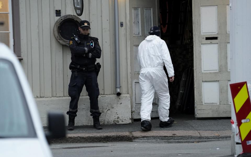 A police technician enters a building in the town center following the deadly attack in Kongsberg - REUTERS