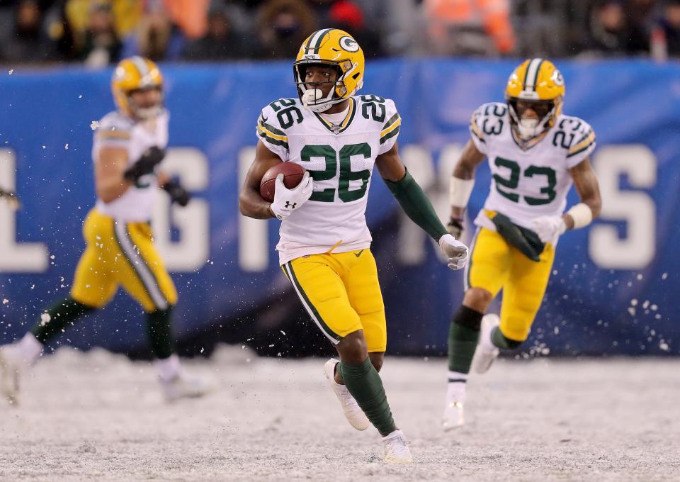 EAST RUTHERFORD, NEW JERSEY - DECEMBER 01: Darnell Savage #26 of the Green Bay Packers carries the ball after he intercepted a pass by Daniel Jones #8 of the New York Giants in the fourth quarter at MetLife Stadium on December 01, 2019 in East Rutherford, New Jersey.The Green Bay Packers defeated the New York Giants 31-13. (Photo by Elsa/Getty Images)