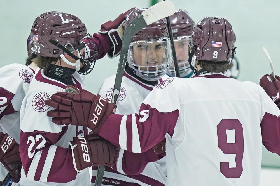 Evan Barbosa, center, is surrounded by his La Salle teammates after his second-period goal during the Rams' 9-0 win over North Kingstown on Friday night.