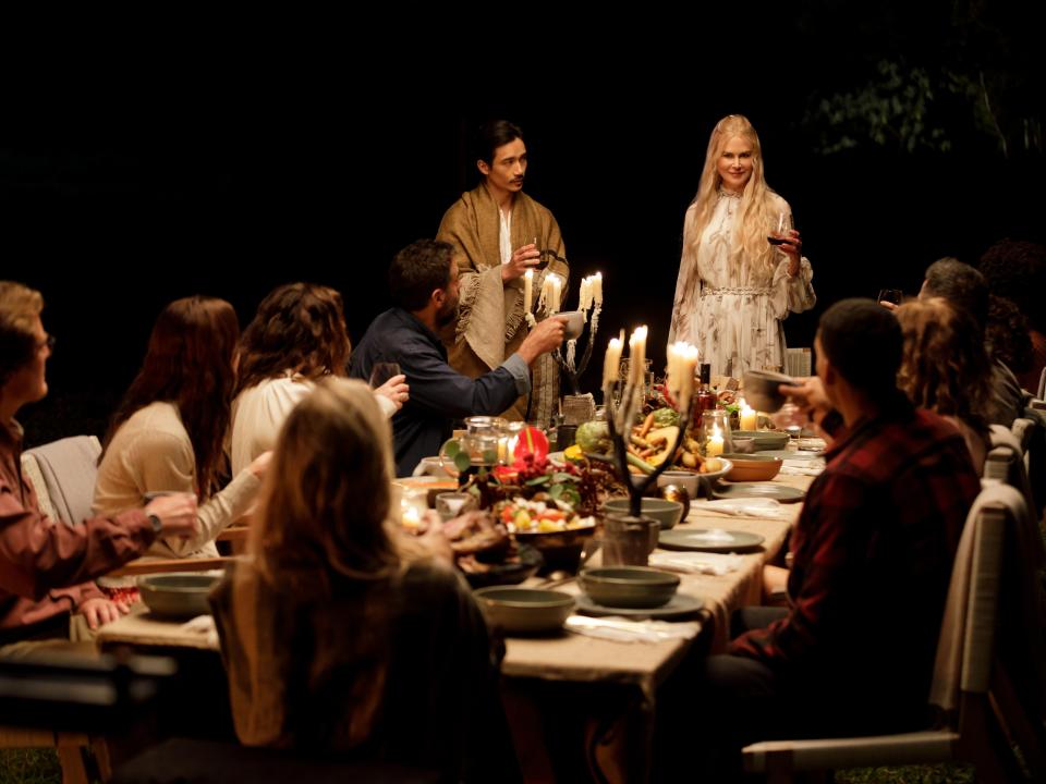 nine perfect strangers group sitting at dinner