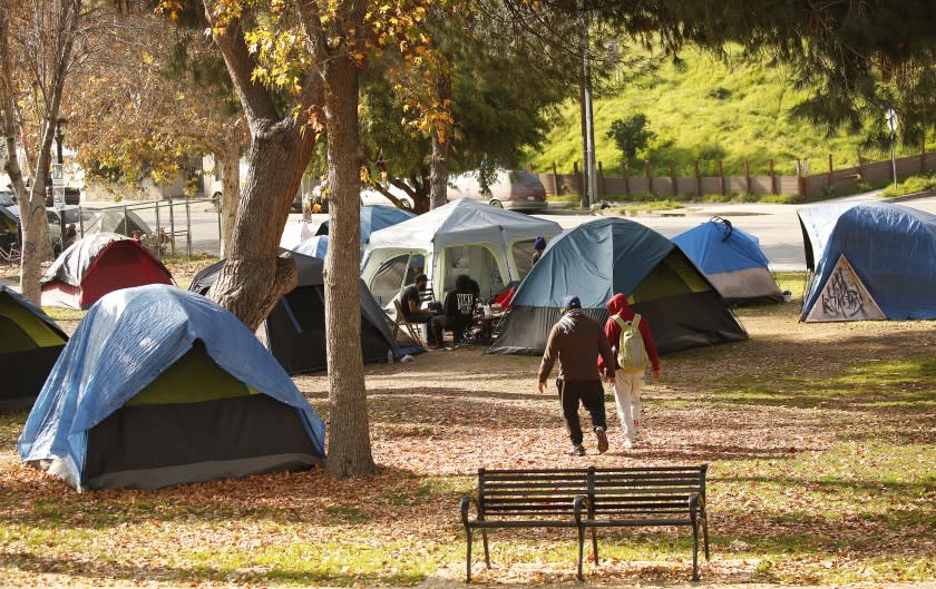 LOS ANGELES, CA - JANUARY 13, 2020 Homeless camping in Echo Park as protesters gathered Monday morning to stop a possible cleaning sweep of a homeless encampment in the northwest corner of Echo Park at Glendale Blvd and Park Avenue. The protesters from the SELAH (Silver Lake, Echo Park, Los Feliz, Atwater Village, East Hollywood, Glassell Park and Cypress Park) Neighborhood Homeless Coalition are angry about the possible eviction of homeless people living around the lake. (Al Seib / Los Angeles Times)