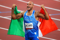 <p>Italy's Lamont Marcell Jacobs celebrates his gold with the Italian flag following the Men's 100m Final at Olympic Stadium on August 1.</p>