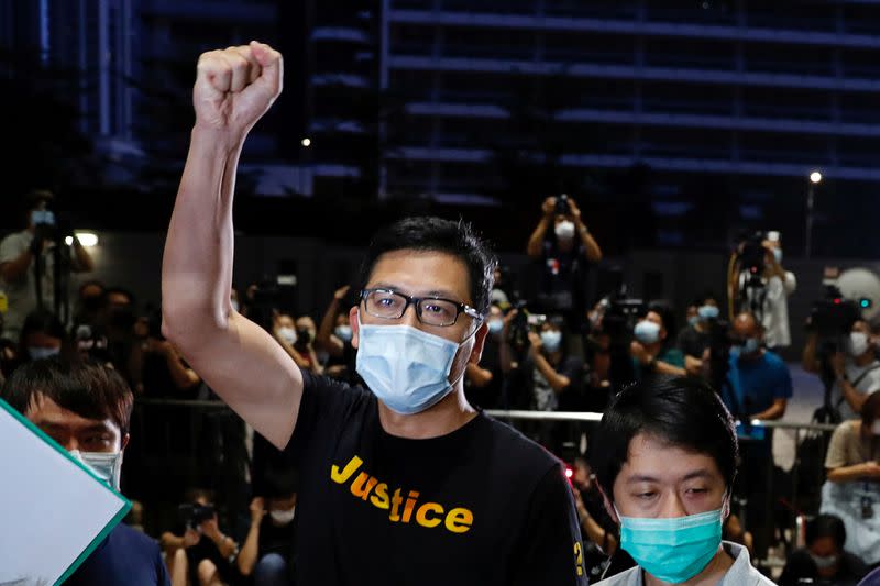 FILE PHOTO: Democratic Party lawmaker Lam Cheuk-ting raises a fist after being released on bail over anti-government protests in July last year at West Kowloon Magistrates' Courts, in Hong Kong, China