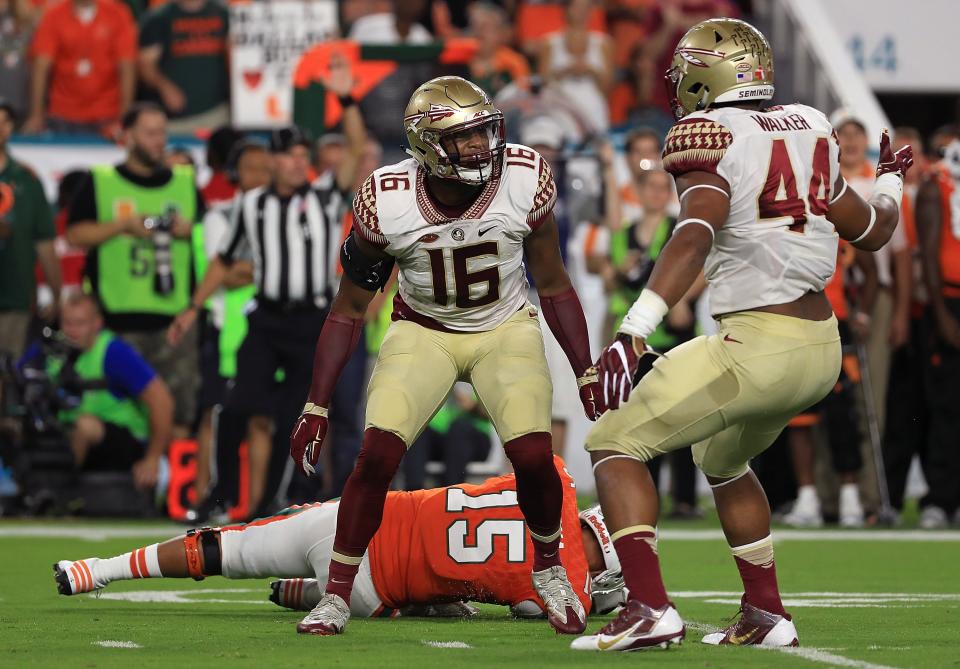 MIAMI GARDENS, FL – OCTOBER 08: Jacob Pugh #16 and DeMarcus Walker #44 of the Florida State Seminoles celebrate a sack on Brad Kaaya #15 of the Miami Hurricanes during a game at Hard Rock Stadium on October 8, 2016 in Miami Gardens, Florida. (Photo by Mike Ehrmann/Getty Images)