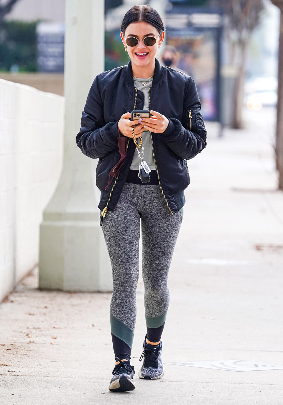 <p>Lucy Hale looks amused by something on her phone while out and about on Jan. 18 in L.A. </p>