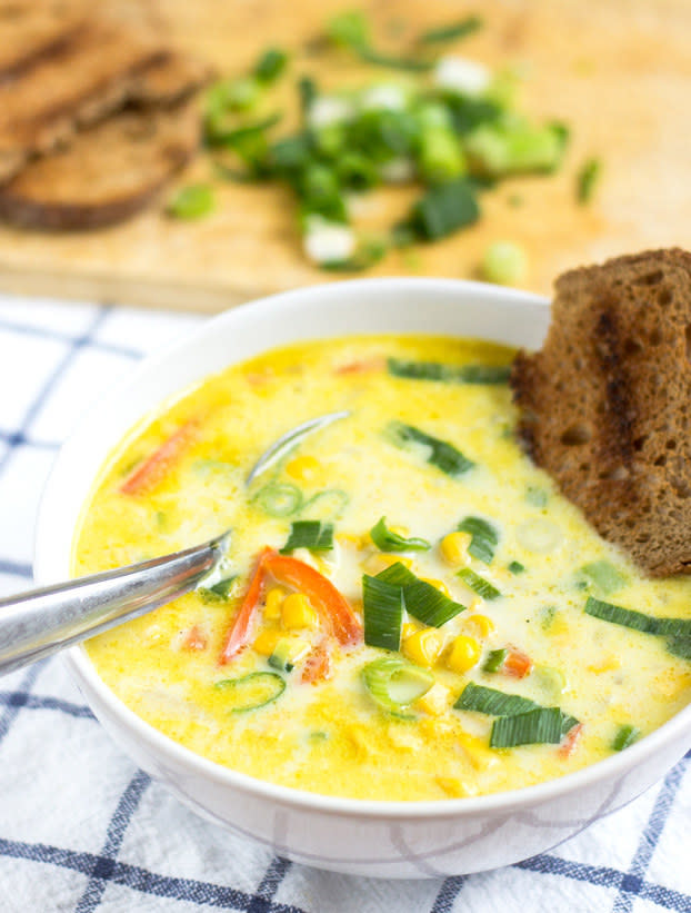 bowl of soup with a piece of bread