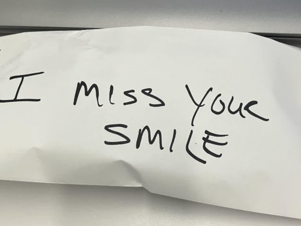 Envelope with "I miss your smile" handwritten on it