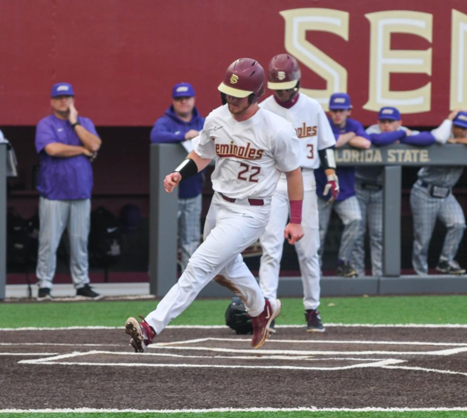 Florida State sophomore James Tibbs scores during the first inning of opening day against James Madison on Feb. 17, 2023, at Dick Howser Stadium.