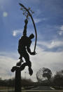 FILE - This April 1, 2014 file photo shows a restored statue and a giant metal globe called the Unisphere, the remaining symbols from the 1964 World's Fair in the Queens borough of New York. This month is the 50th anniversary of the 1964 New York World’s Fair. (AP Photo/Bebeto Matthews)