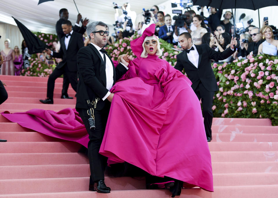 FILE - Lady Gaga, right, and designer Brandon Maxwell are pictured together, May 6, 2019, at The Metropolitan Museum of Art's Costume Institute benefit gala, celebrating the opening of the "Camp: Notes on Fashion" exhibition, in New York. Throughout history, designers, artists, and brands have played with the emotions the color evokes, shaping meanings that are ever-evolving. From gender to class, those associations have constantly been challenged, flipped and subverted — while the definition of pink is always in flux, there's one constant: its cultural staying power. (Photo by Evan Agostini/Invision/AP, File)