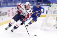 Washington Capitals forward Carl Hagelin (62) carries the puck past Buffalo Sabres forward Sam Reinhart (23) during the first period of an NHL hockey game, Friday, Jan. 15, 2021, in Buffalo, N.Y. (AP Photo/Jeffrey T. Barnes)