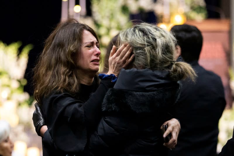 Mourners attend a memorial for the victims of a Ukrainian passenger plane which was shot down in Iran