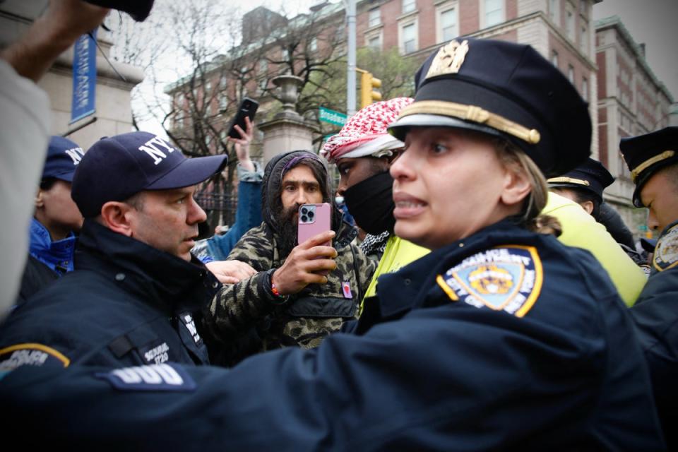 NYPD officers detain a person as pro-Palestinian protesters gather outside of Columbia University in New York City on April 18, 2024 (AFP via Getty Images)