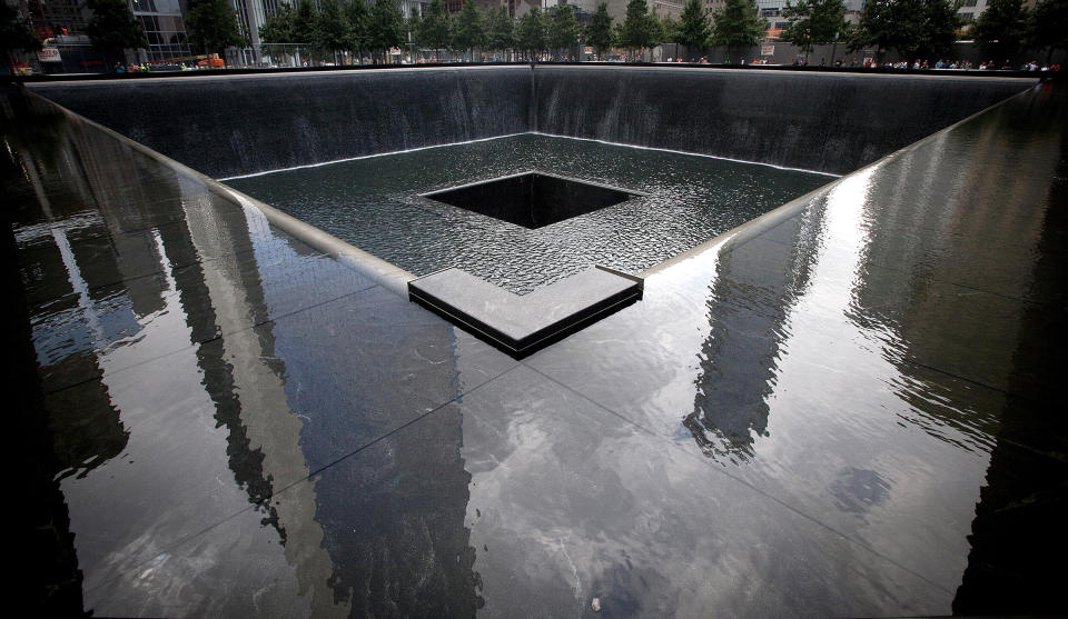 Buildings are reflected in the South Pool of the National September 11 Memorial in New York on Aug. 29, 2013. | Carlo Allegri—Reuters.