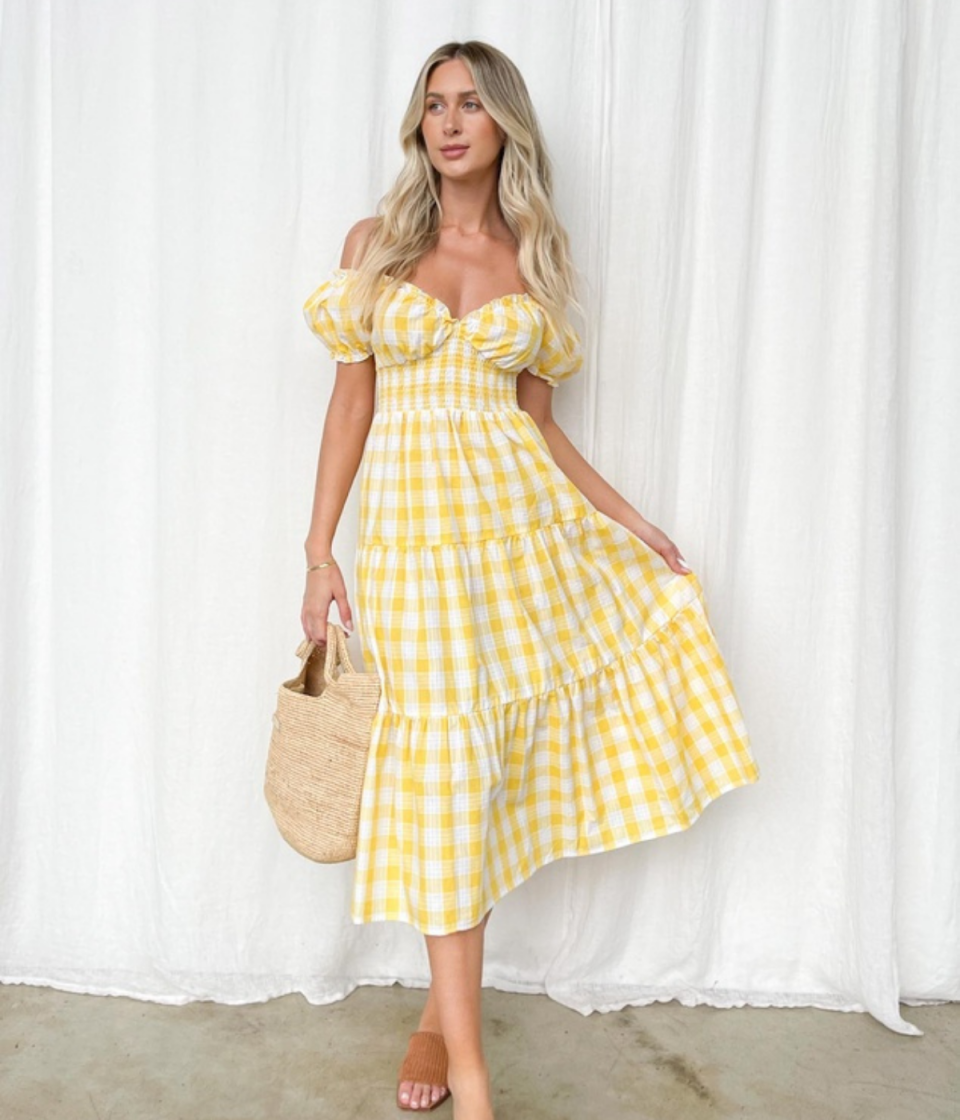 Dazie Pinot Grigio Midi Dress from The Iconic in yellow gingham, tiered flounces and off-the shoulder short puffed sleeves.