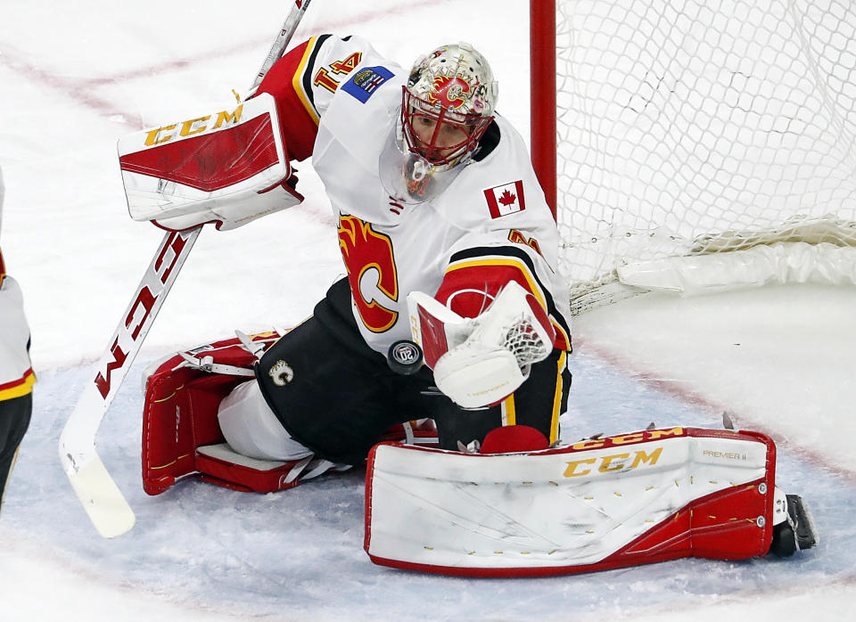 Calgary Flames goaltender Mike Smith (41) eyes the puck during the third period of an NHL hockey game against the Carolina Hurricanes, Sunday, Jan. 14, 2018, in Raleigh, N.C. (AP Photo/Karl B DeBlaker)