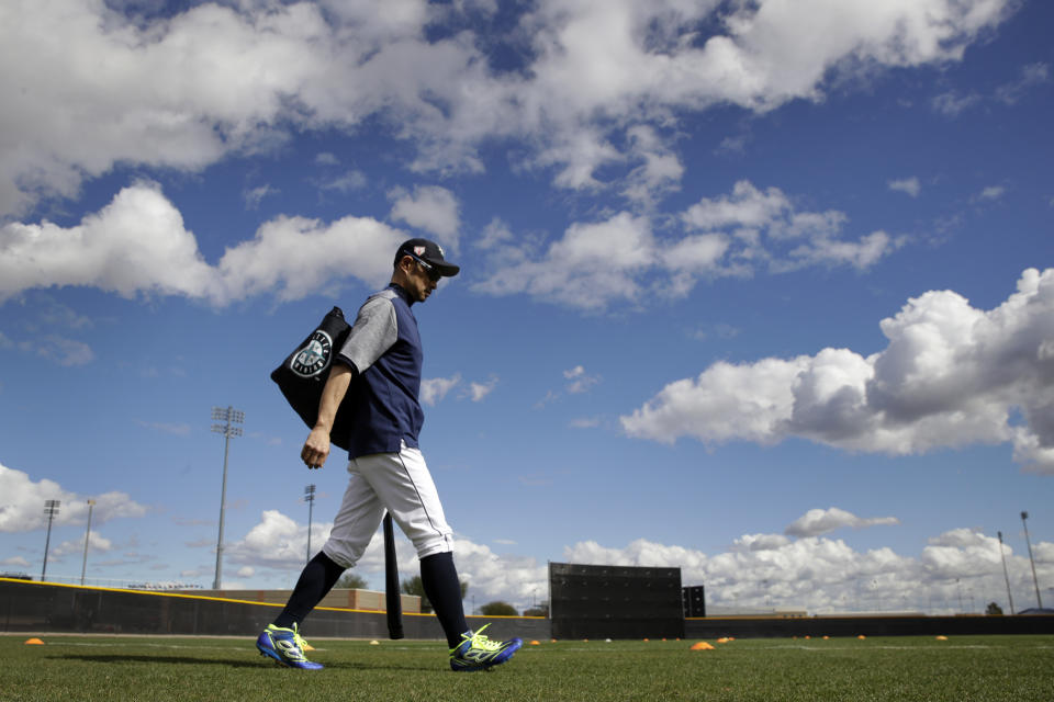 Seattle Mariners' Ichiro Suzuki walks onto a practice field during baseball spring training Saturday, Feb. 16, 2019, in Peoria, Ariz. (AP Photo/Charlie Riedel)