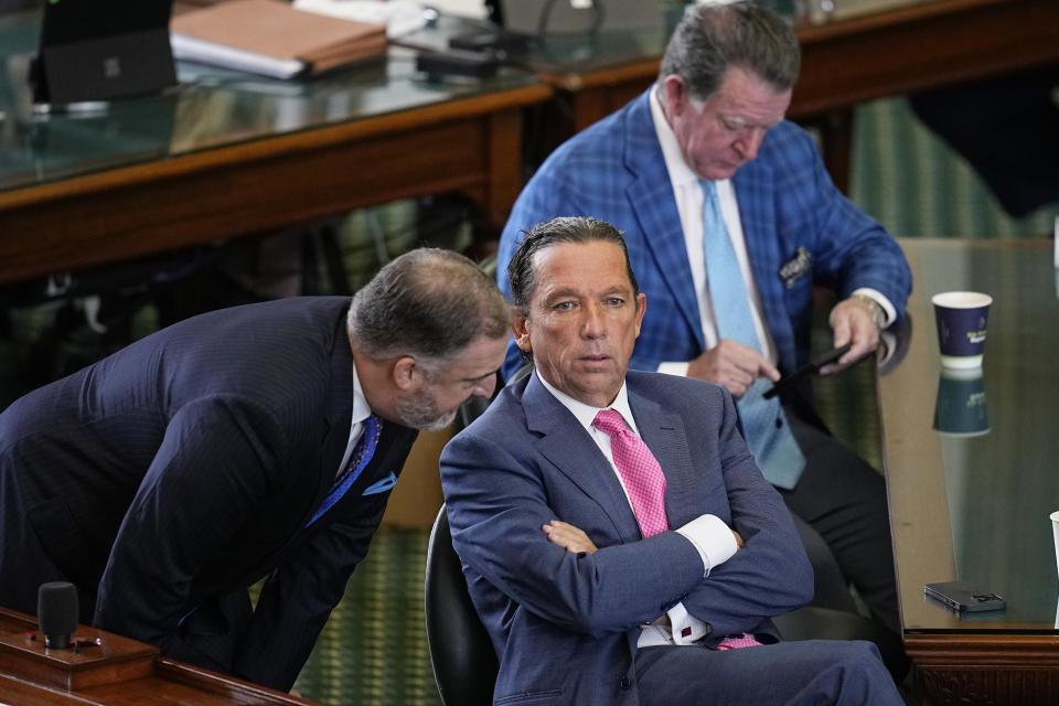 Defense attorneys Mitch Little, left, Tony Buzbee, center, and Dan Cogdell, right, wait for Texas state Senators acting as jurors to return to the Senate chamber for their verdict in the impeachment trial for suspended Texas Attorney General Ken Paxton at the Texas Capitol, Saturday, Sept. 16, 2023, in Austin, Texas. (AP Photo/Eric Gay)