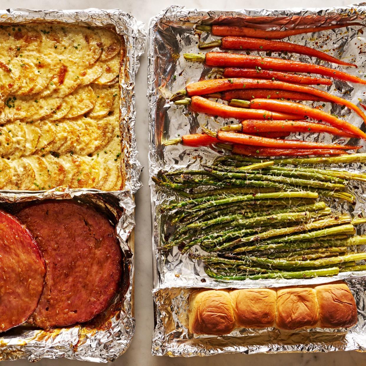 sheet pan easter dinner with glazed ham, gruyere scalloped potatoes, roasted carrots, roasted asparagus, and rolls