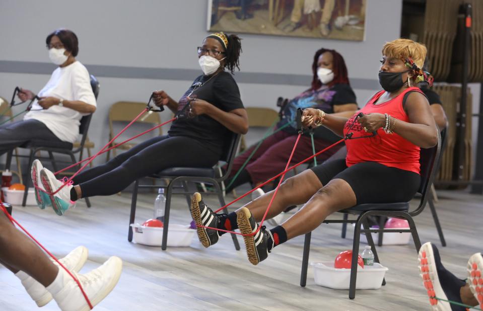 Priscilla Wilson, Rochester, right, and the rest of the class use bands to build and maintain strength in their legs and core during a Silver Sneakers fitness class put on by Exercise Express LLC in the community room at Aenan Baptist Church in Rochester Wednesday, Aug. 3, 2022.  