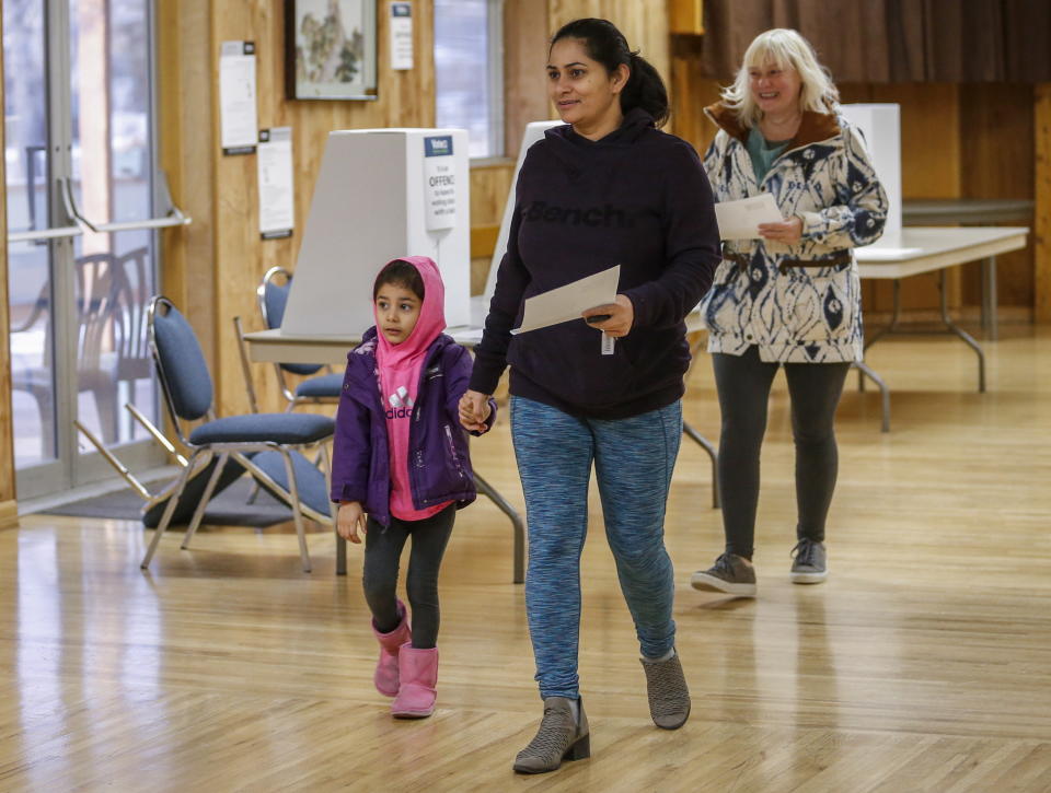 Calgarians votes in a plebiscite, Tuesday, Nov. 13, 2018, in Calgary, Alberta, on whether the city should proceed with a bid for the 2026 Winter Olympics. (Jeff McIntosh/The Canadian Press via AP)