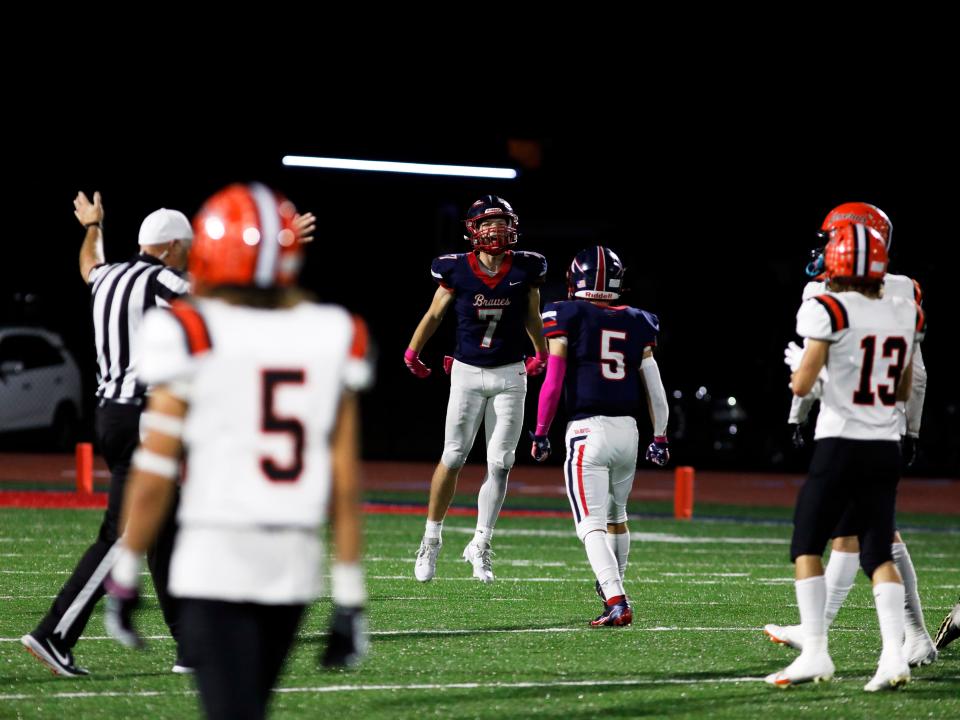 Kolton Thomas, left, celebrates a fumble recovery with teammate Tanyon McComb during the fourth quarter of a 34-12 win against visiting Ridgewood on Friday night in Gnadenhutten.