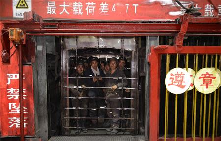 Miners wait in an elevator to go down into a coal mine in Lvliang, Shanxi province in this June 17, 2012 file photo. REUTERS/Stringer/Files